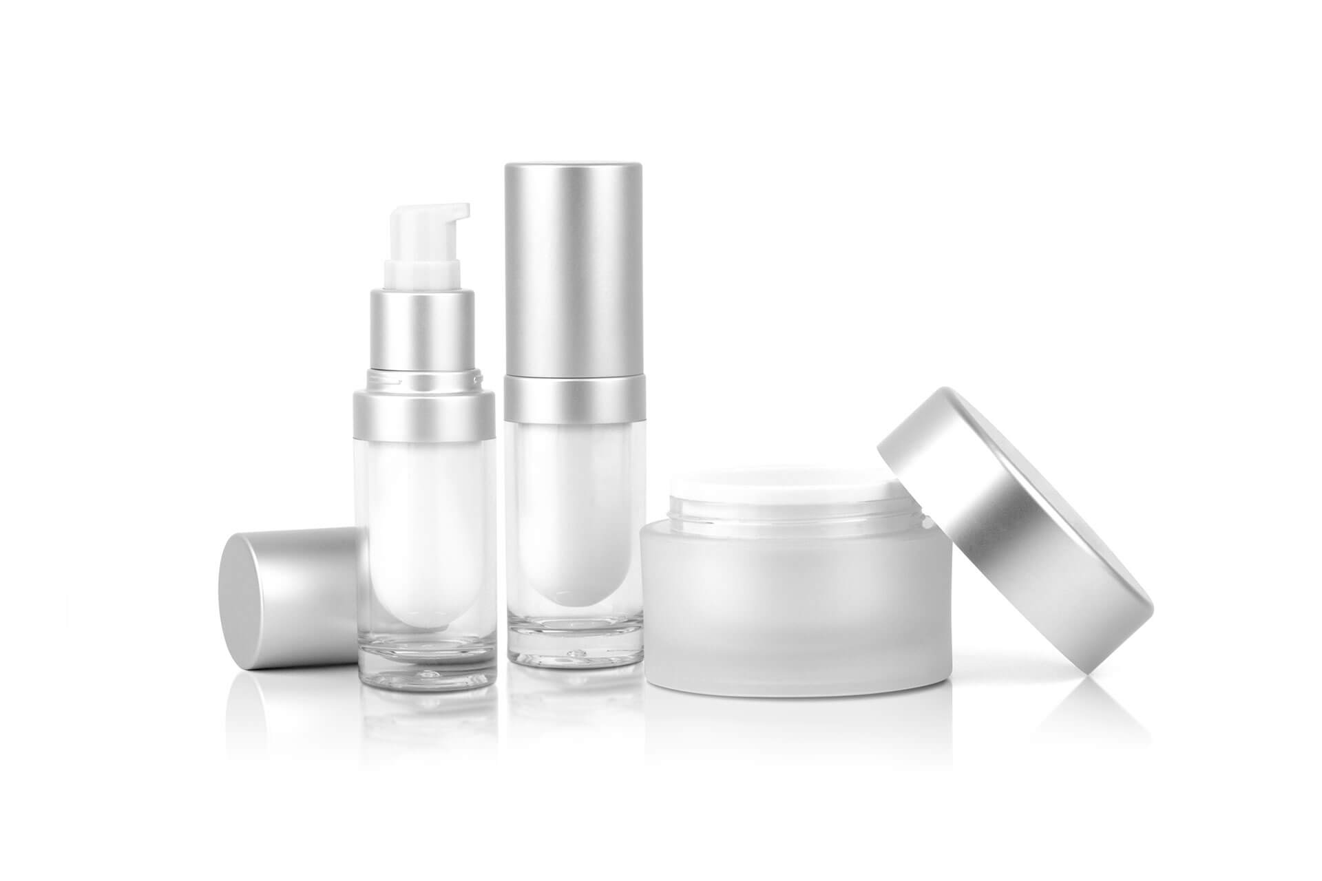 photo of a white background with three silver bottles